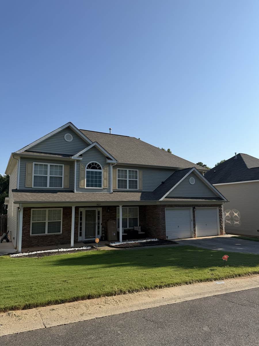 Full, healthy front lawn maintained by OSO Turf Care