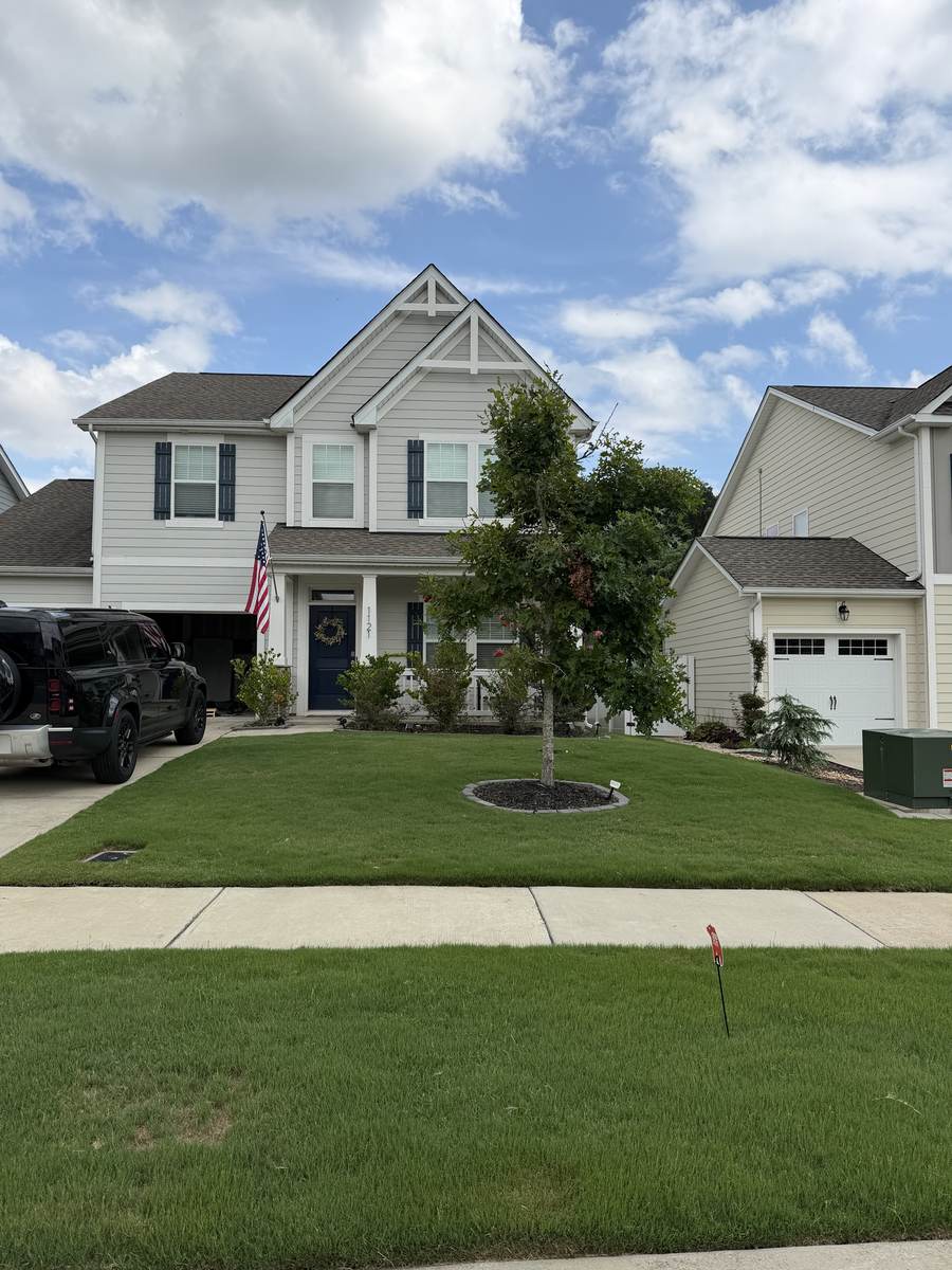 Healthy green lawn with an OSO Turf Care yard sign